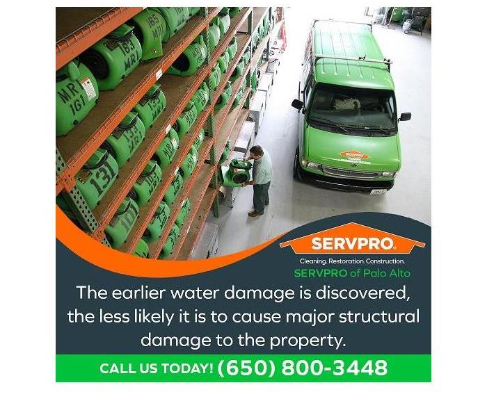 SERVPRO technician in the warehouse, checking out restoration equipment. The SERVPRO truck is parked next to him.